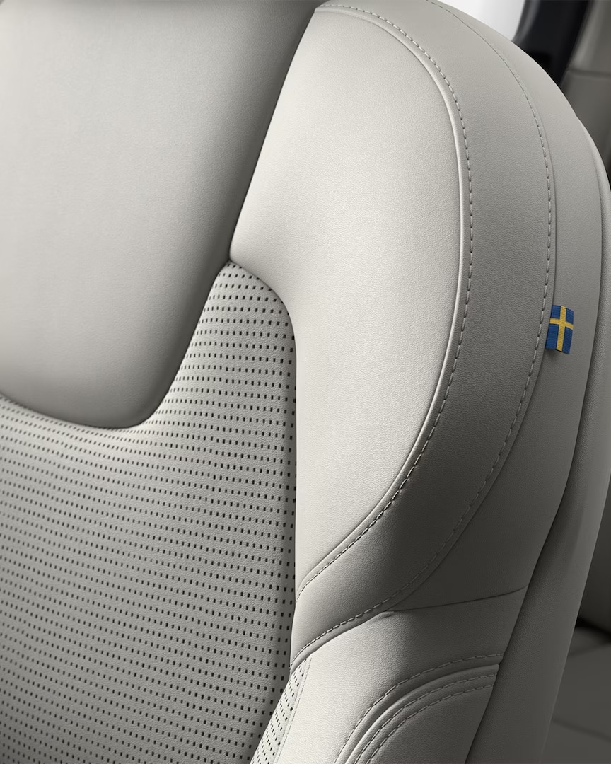 Close-up of the stitching on the Volvo XC90 mild hybrid’s front passenger seat featuring a tiny Swedish flag.