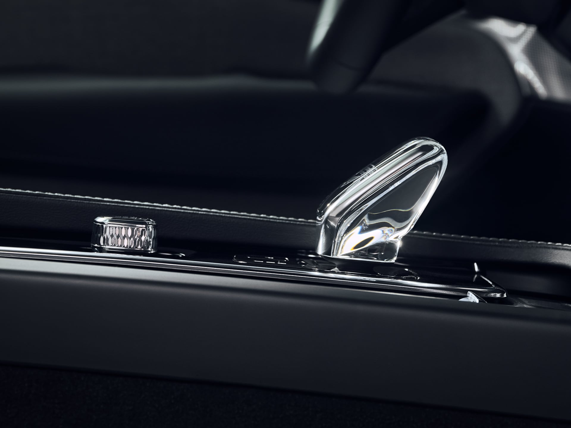 Start button and available crystal gear shifter in the center console of the Volvo XC90 Recharge plug-in hybrid.
