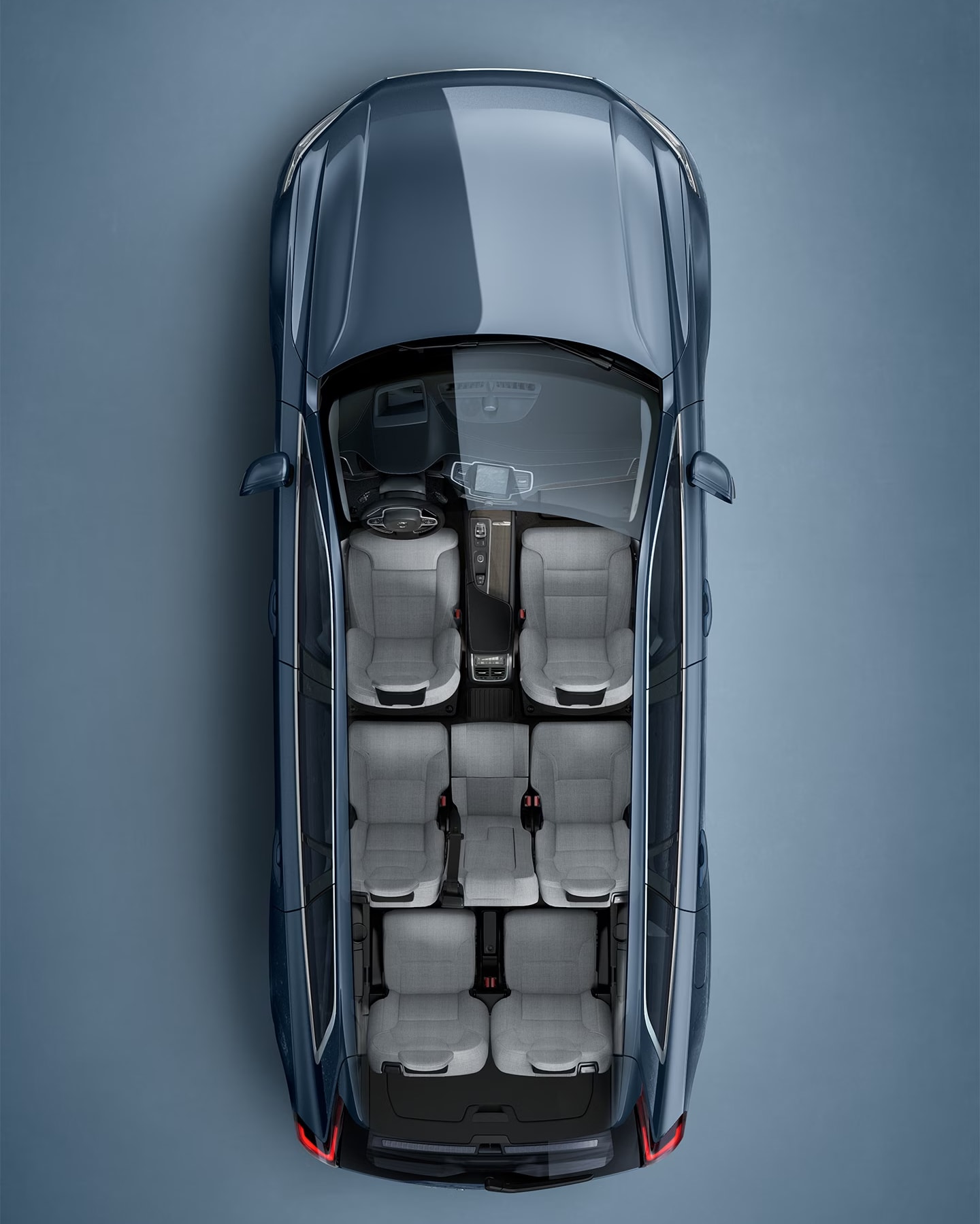 A blue Volvo XC90 SUV seen from directly above with interior visible.