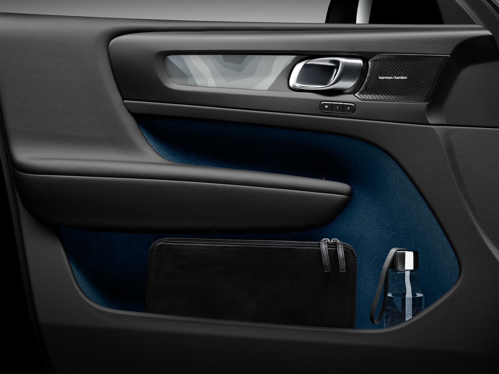The large door pocket in the Volvo EC40 holds a laptop and a water bottle.