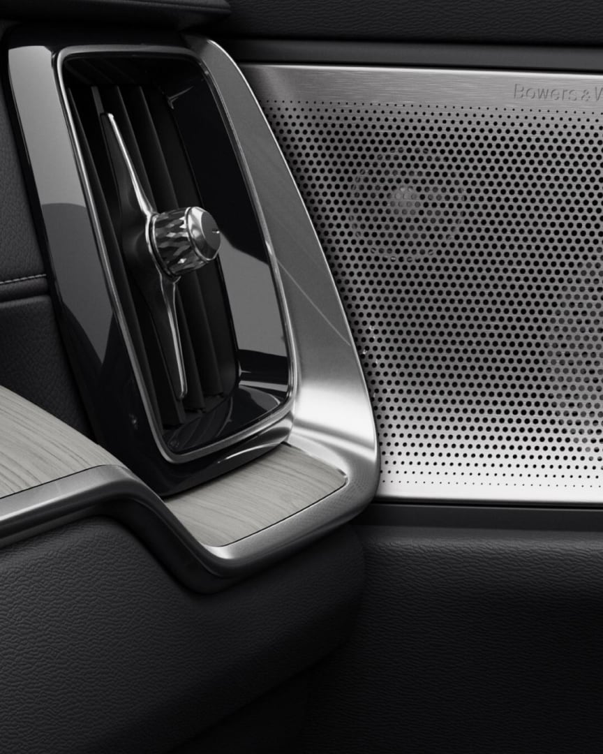 Close-up of a Bowers & Wilkins door speaker and passenger controls in the Volvo V60 plug-in hybrid.