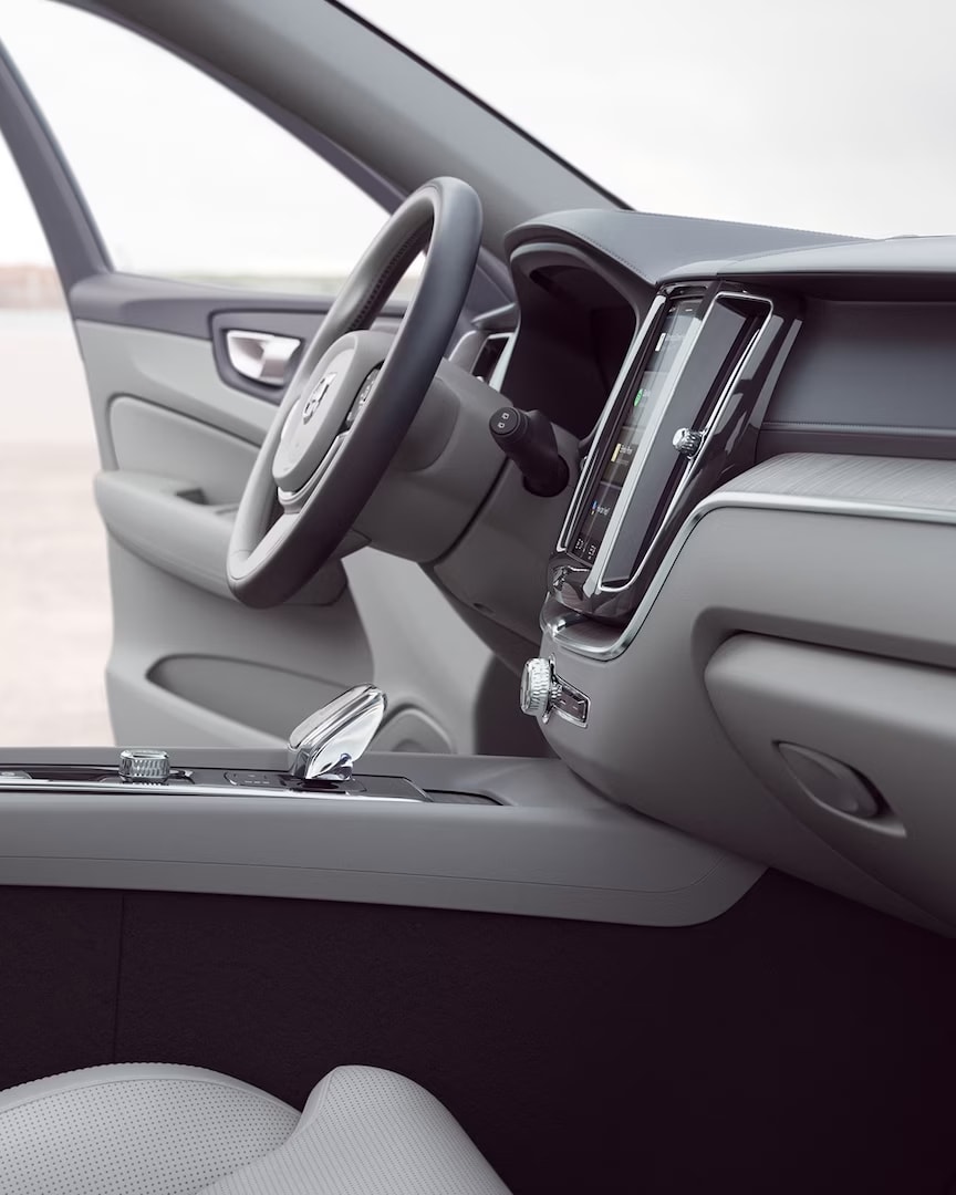 Front interior of Volvo XC60 with driver door open.