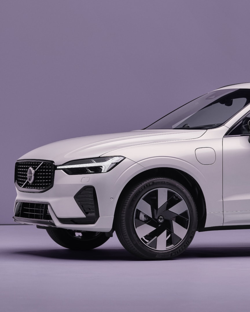 Side view of a Volvo XC60 plug-in hybrid showing the wheel and the front of the car.