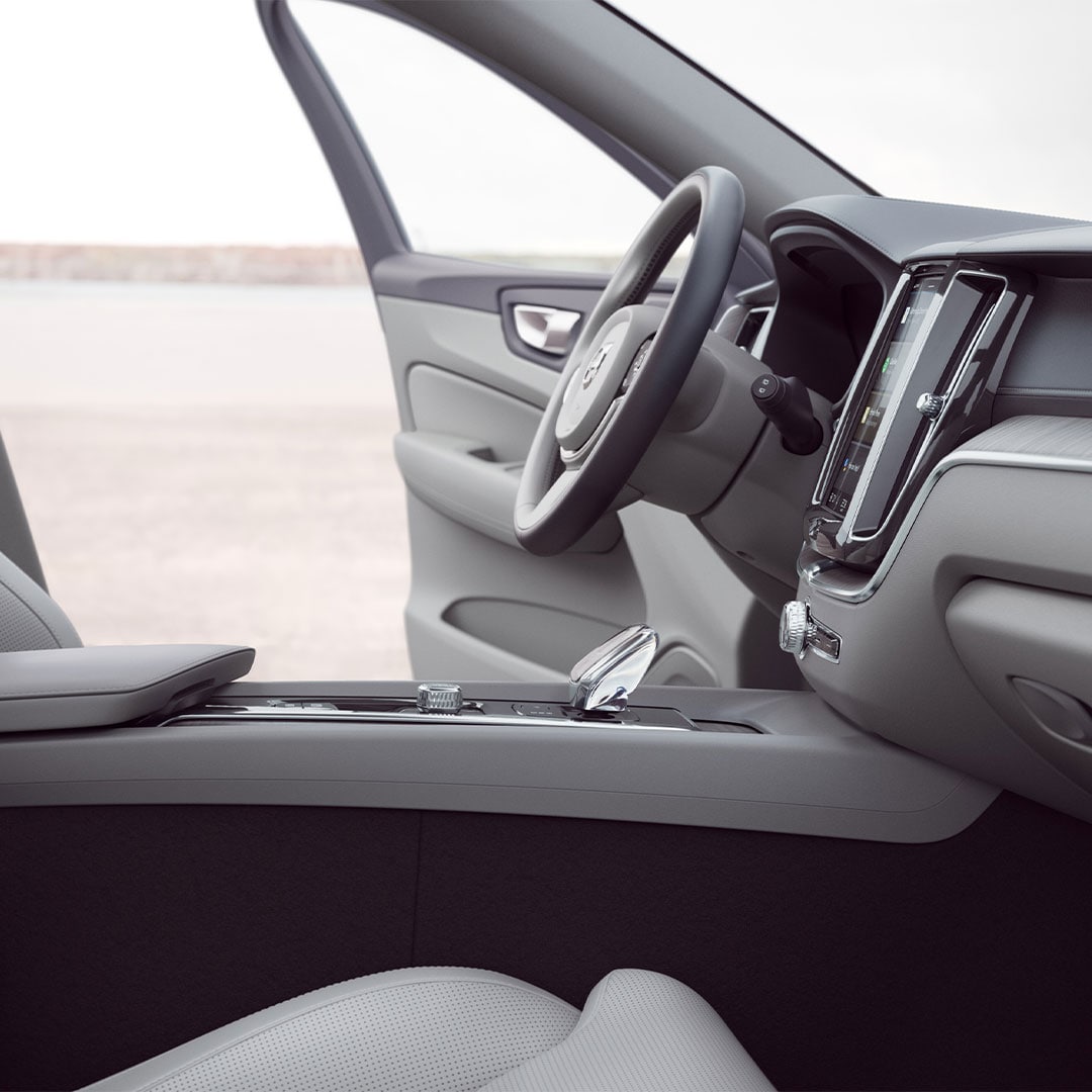 Front interior of Volvo XC60 plug-in hybrid with driver door open.