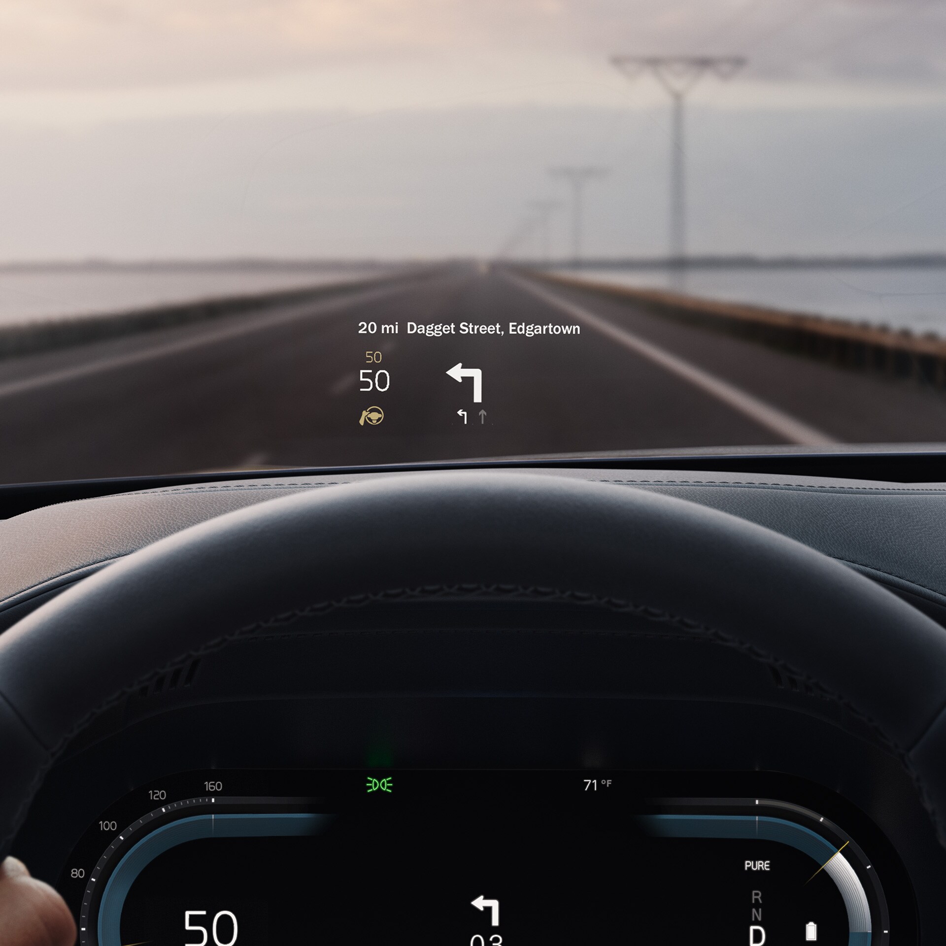 Inside a Volvo, head-up display showing driving speed and navigation on the windshield. 