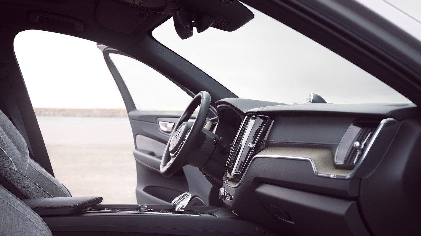 Front interior of Volvo XC60 Recharge with driver door open.