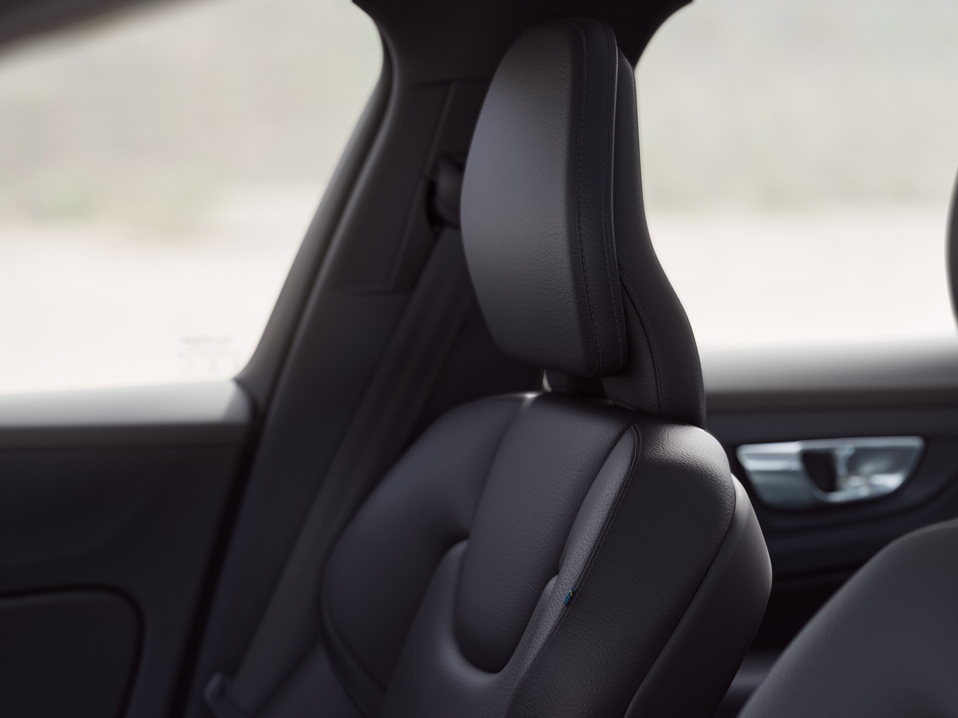 Close-up of an ergonomic upholstered seat in a Volvo sedan.