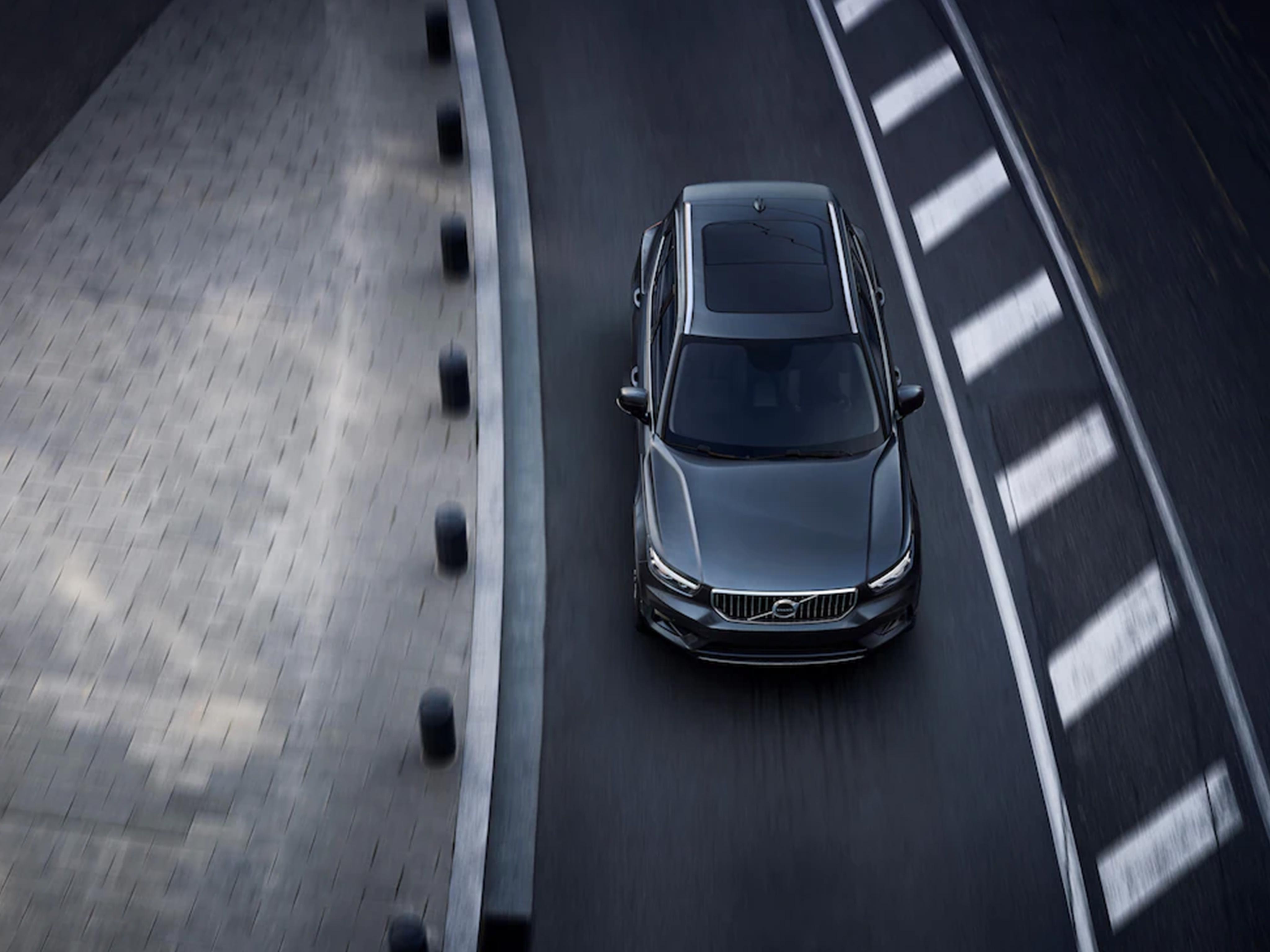 Black Volvo driving on road