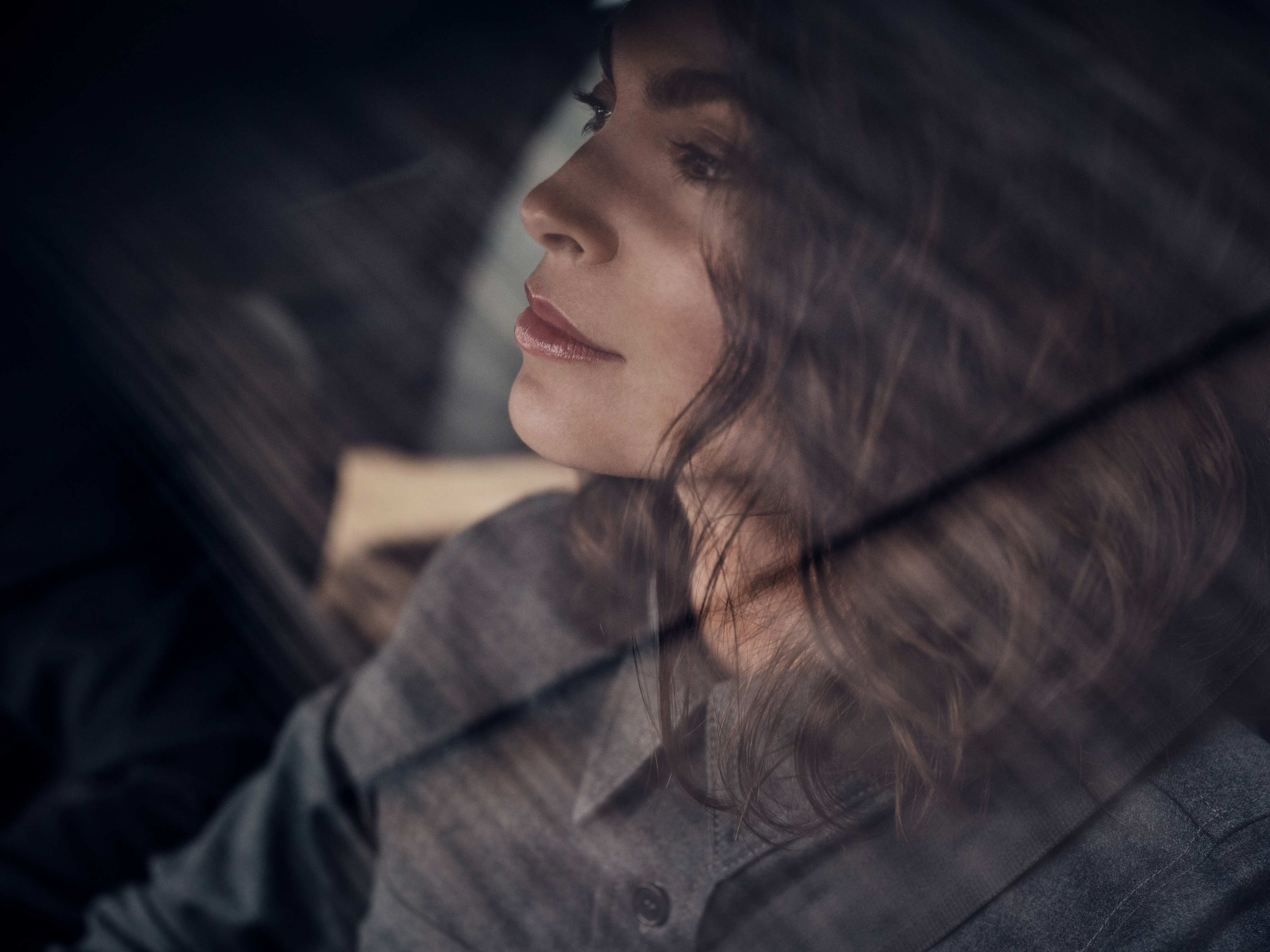 Woman behind the window sitting in a Volvo car.