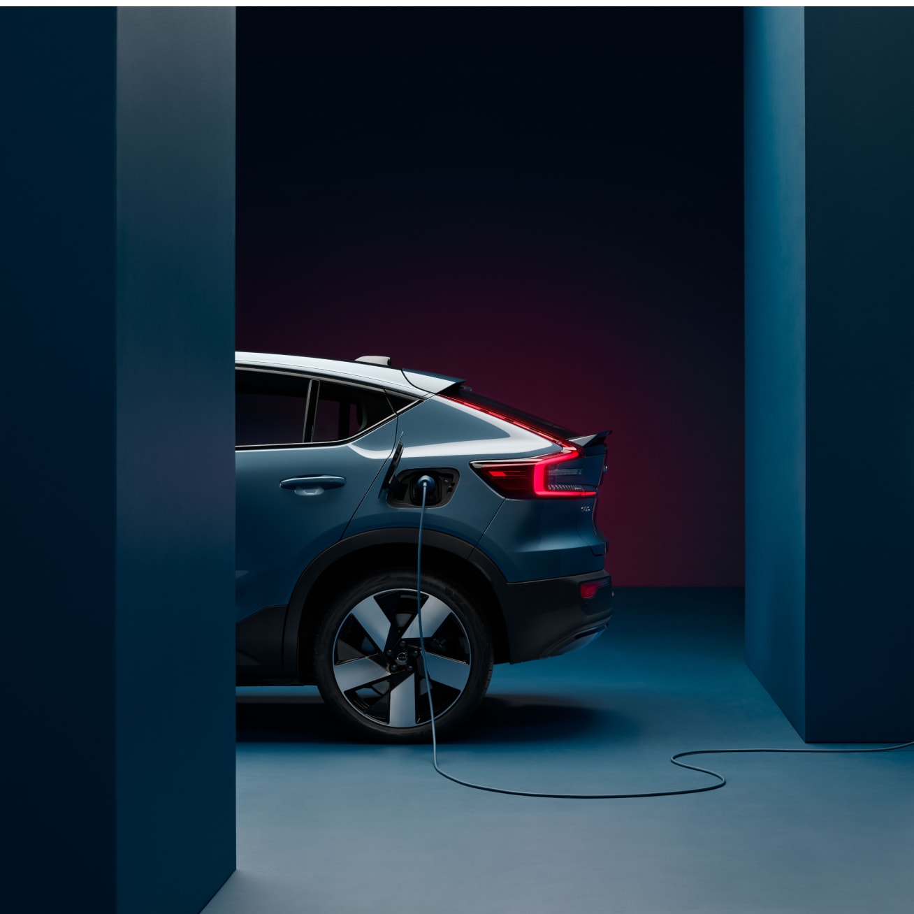 Partial view of rear side of Volvo XC40 charging at charging post