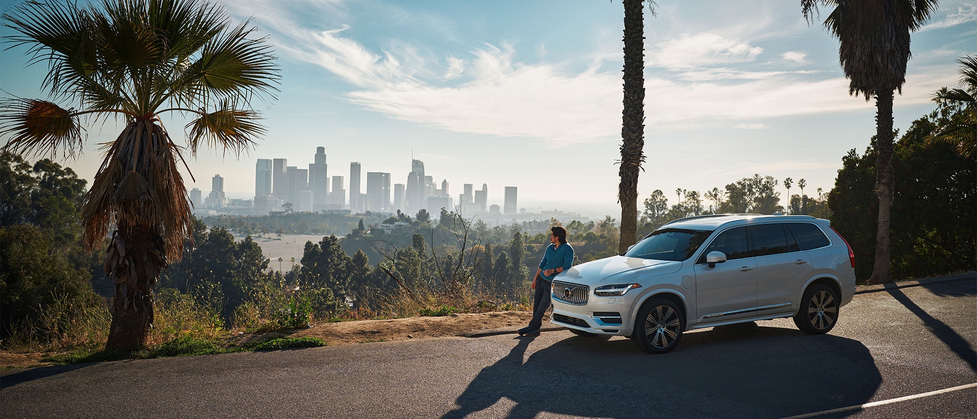 Volvo XC90 Recharge plug-in hybrid parked in front of scenic overlook 