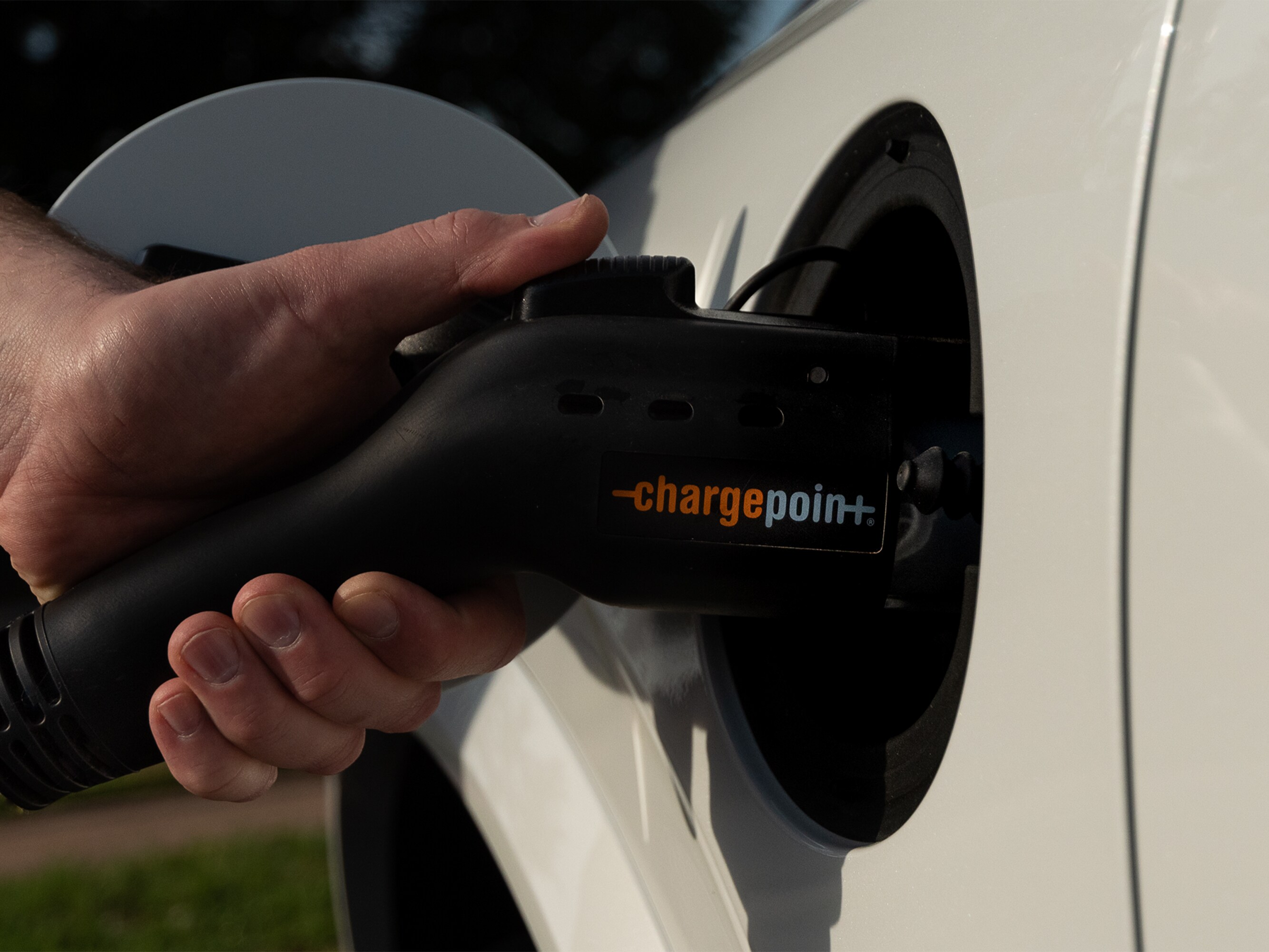 Mans hand charging Volvo with Chargepoint