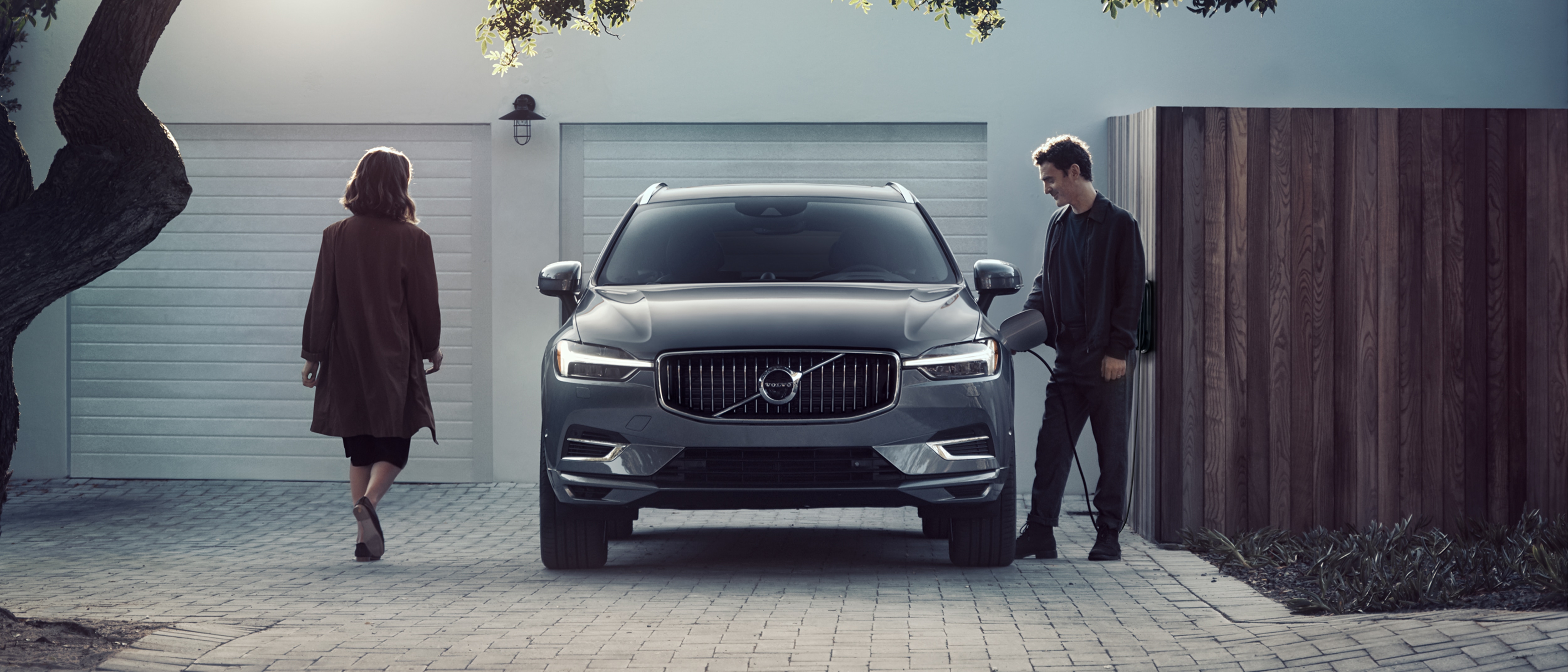 Man charging Volvo SUV front view