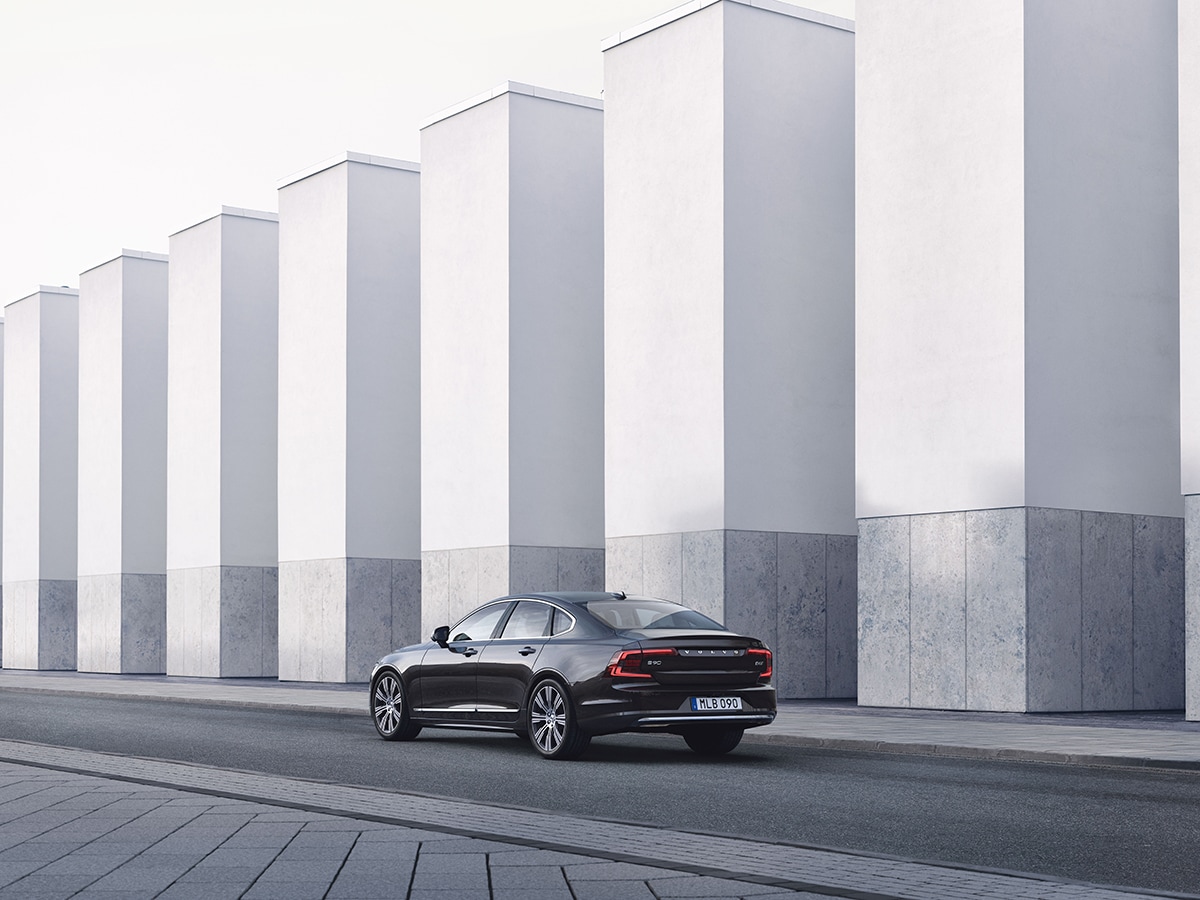 Volvo Livery Ordering Process - Sedan driving by concrete buildings