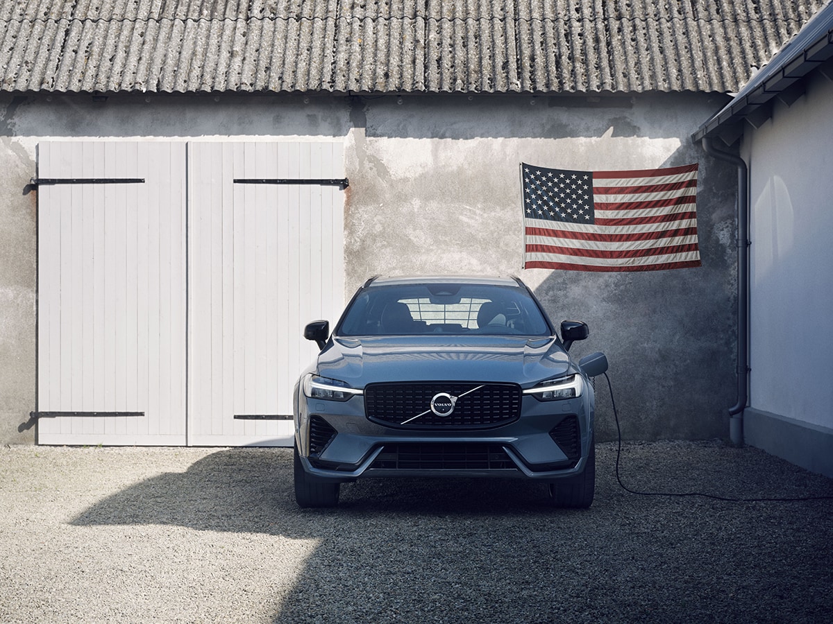Volvo US Military Program - Volvo in front of garage with USA flag