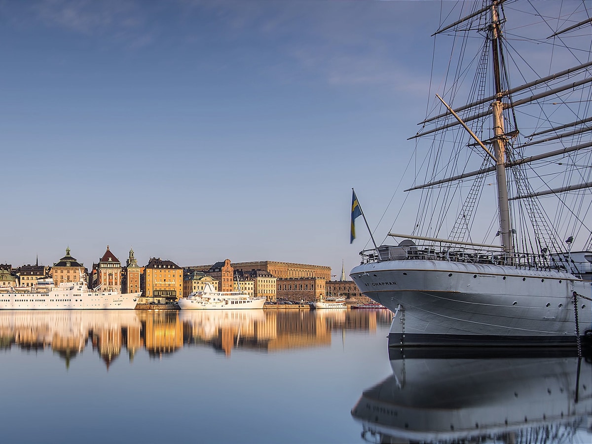 Volvo Overseas Delivery - Boat on water in front of Swedish town