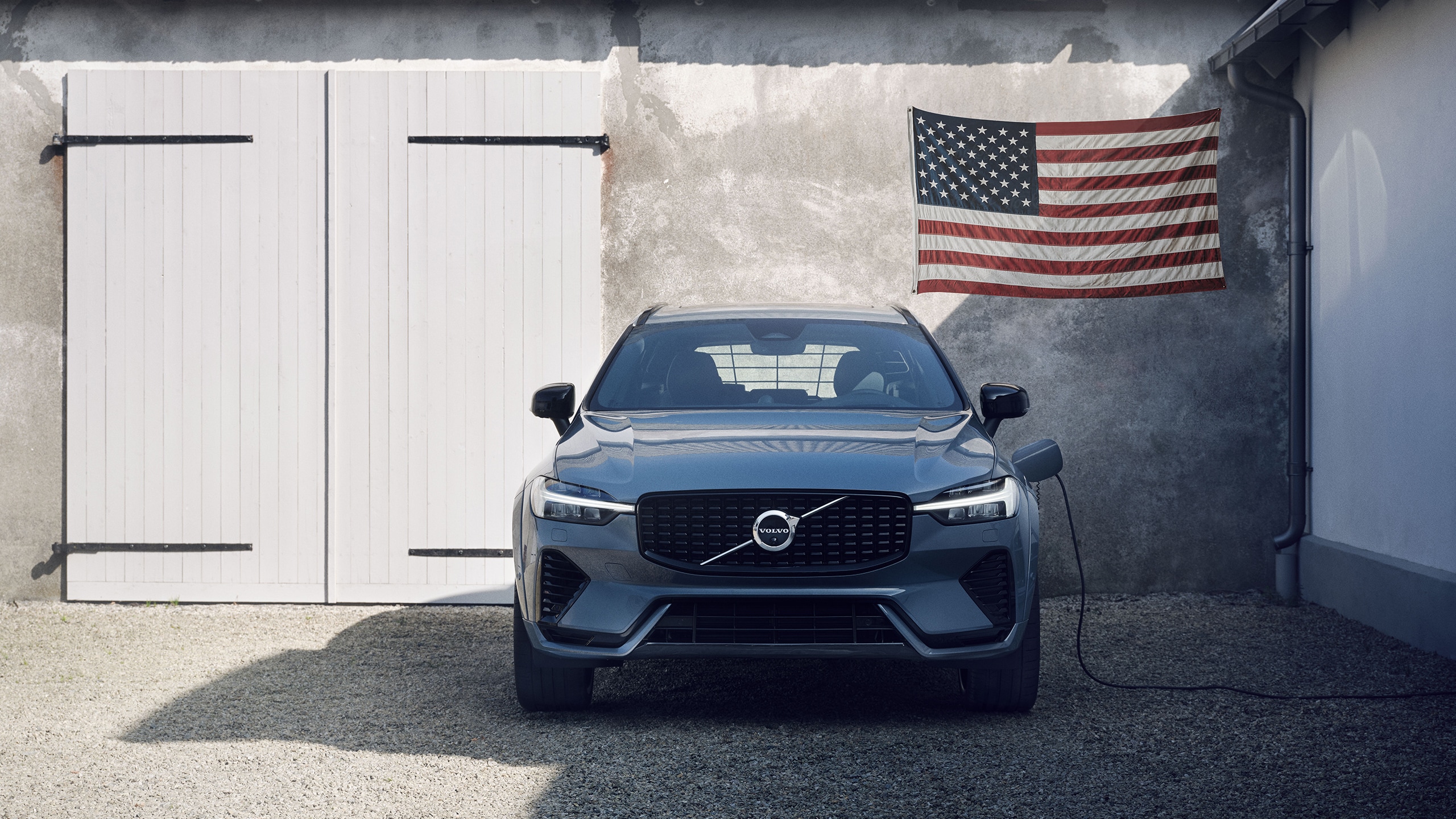 Volvo Military Program - Volvo parked by garage with American flag