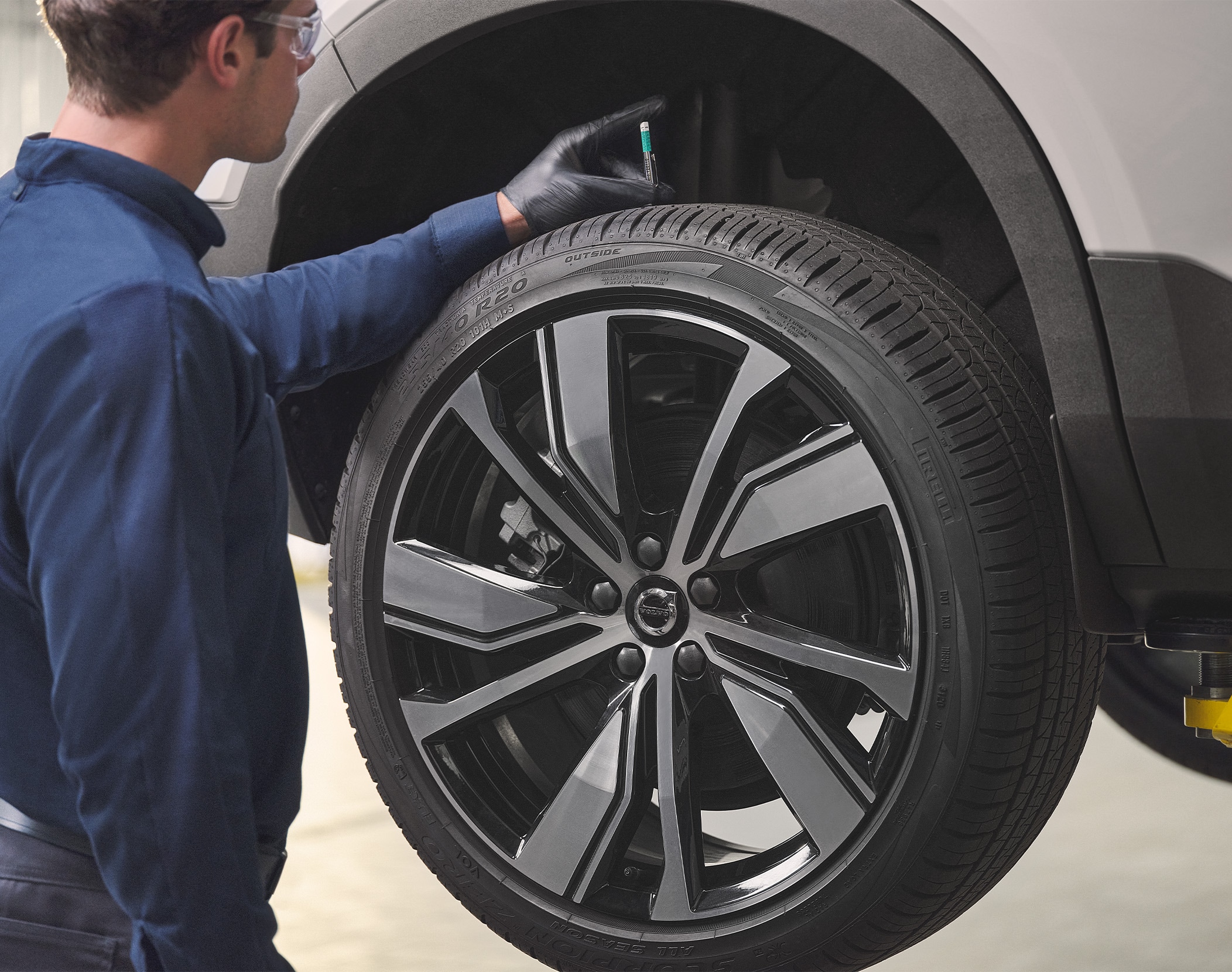 The Best Tires for a Volvo - Mechanic checking tire on a car