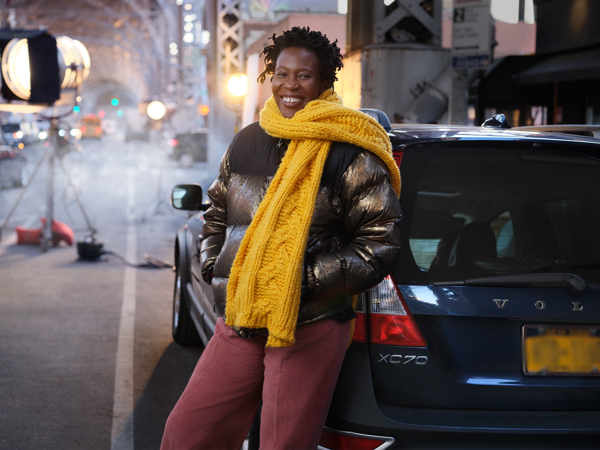 Woman with Large Yellow Scarf Leaning on Volvo - Volvo Women's Stories Tiffany N.
