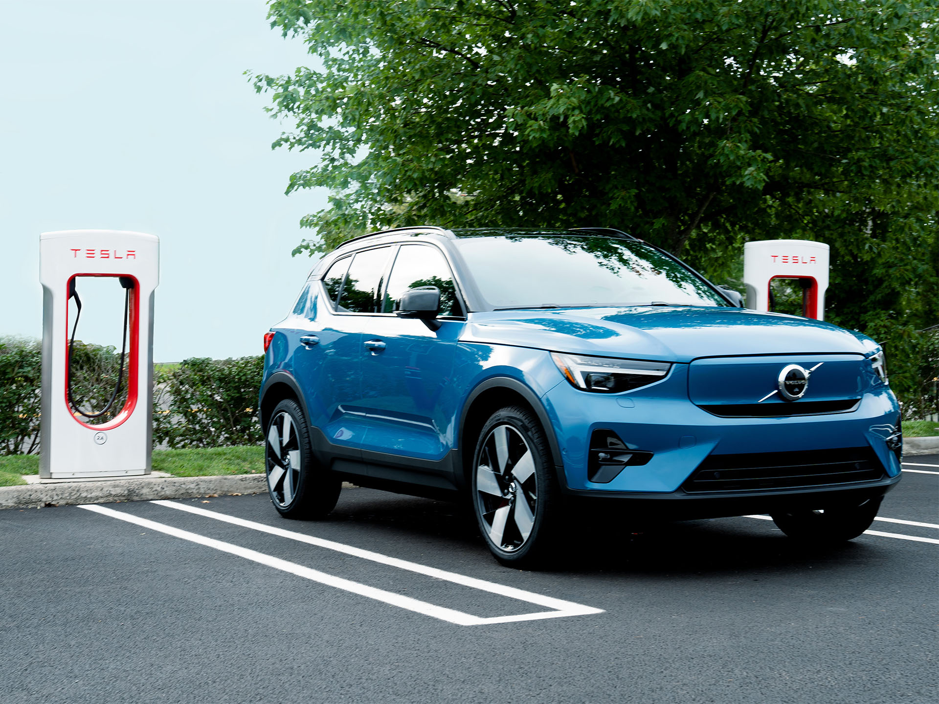 Fjord Blue Volvo XC40 Recharge fully electric parked at Tesla Supercharger - North American Charging Standard (NACS)