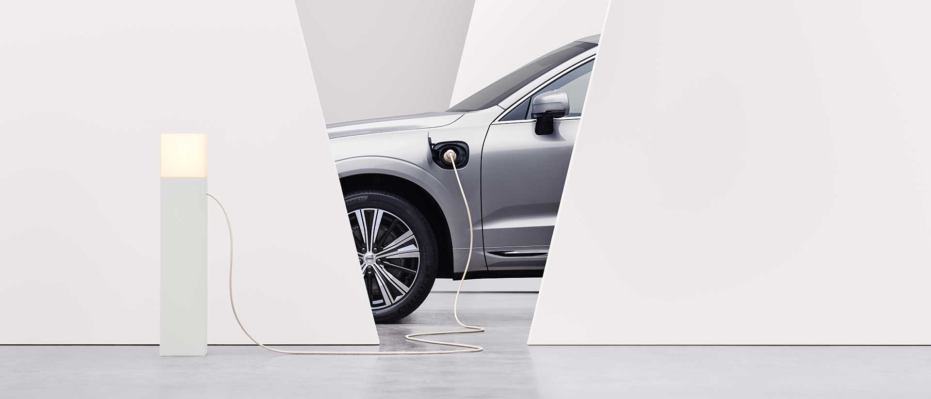 A Volvo car gets charged at a charging station.