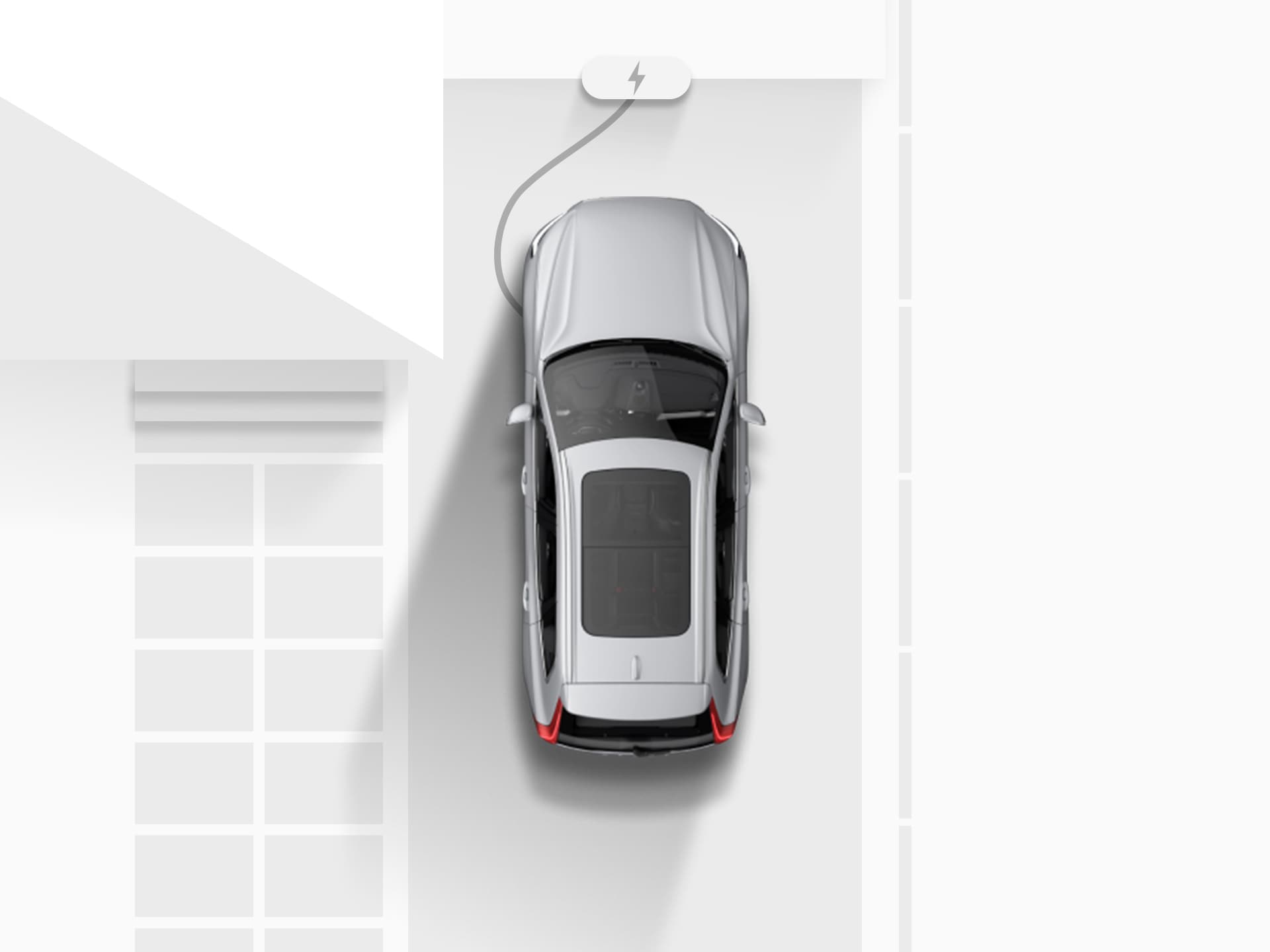 Pohľad zhora na digitálnu kresbu strieborného SUV Volvo XC40 Recharge Pure Electric pripojeného k elektrickej sieti pri nabíjaní na príjazdovej ceste k domu.