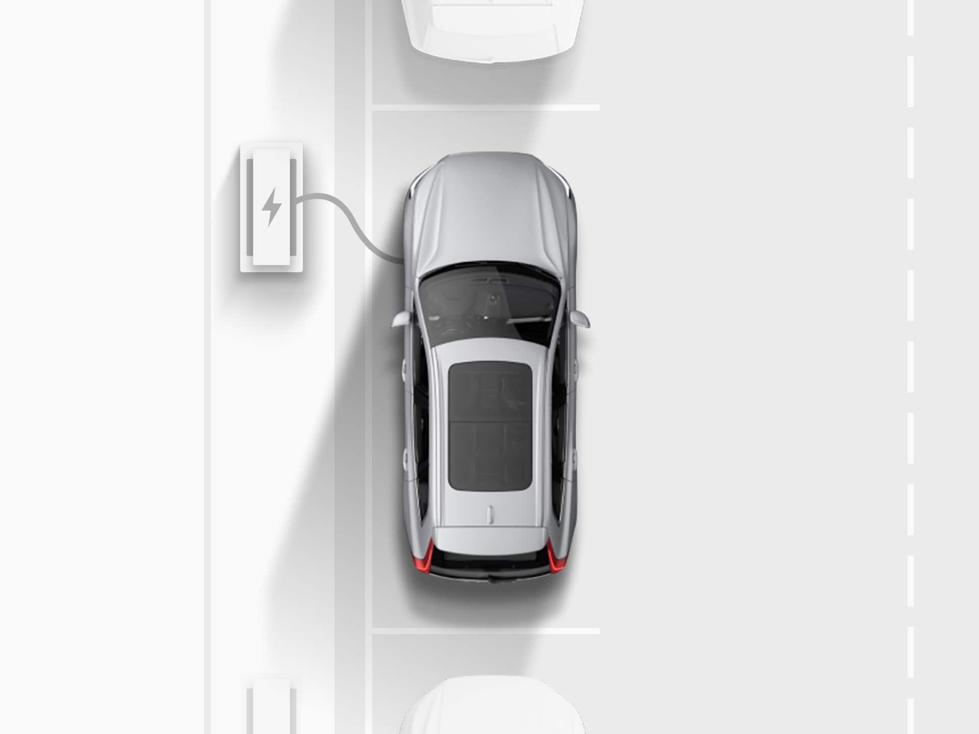 ภาพมุมสูงของภาพวาดดิจิตอลของ Volvo XC40 Recharge SUV ระบบไฟฟ้าสีเงิน ที่กำลังเสียบสายชาร์จกับจุดชาร์จไฟ ขณะจอดเทียบอยู่บนถนนสาธารณะ