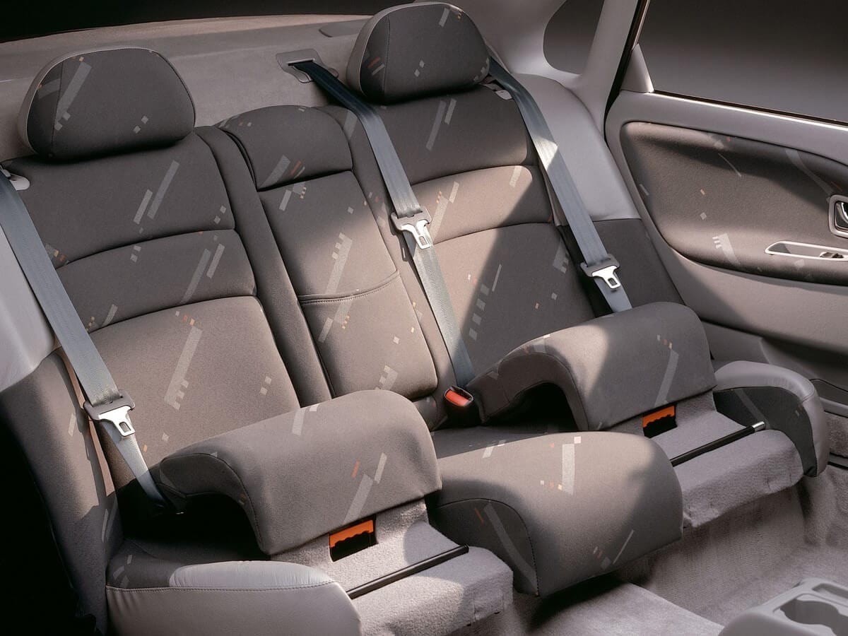 Integrated booster cushions for outer rear seats were launched by Volvo Cars in 1995.