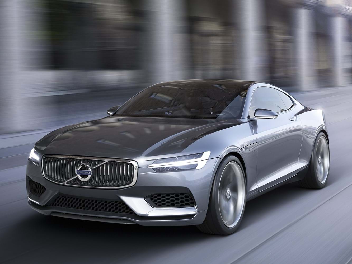 The Volvo Concept Coupe drives down a city street