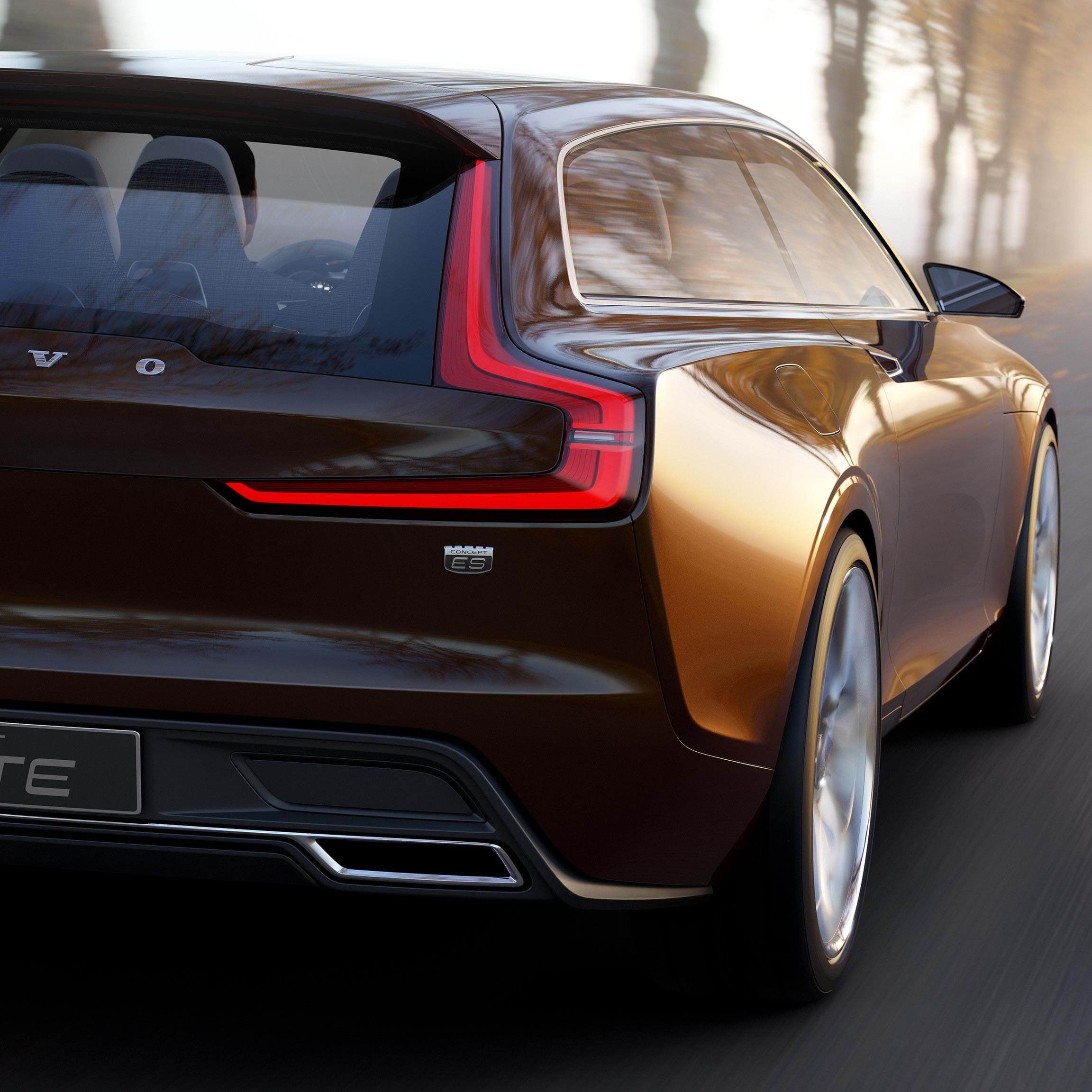 Volvo Concept Estate driving up tree-lined lane seen from rear