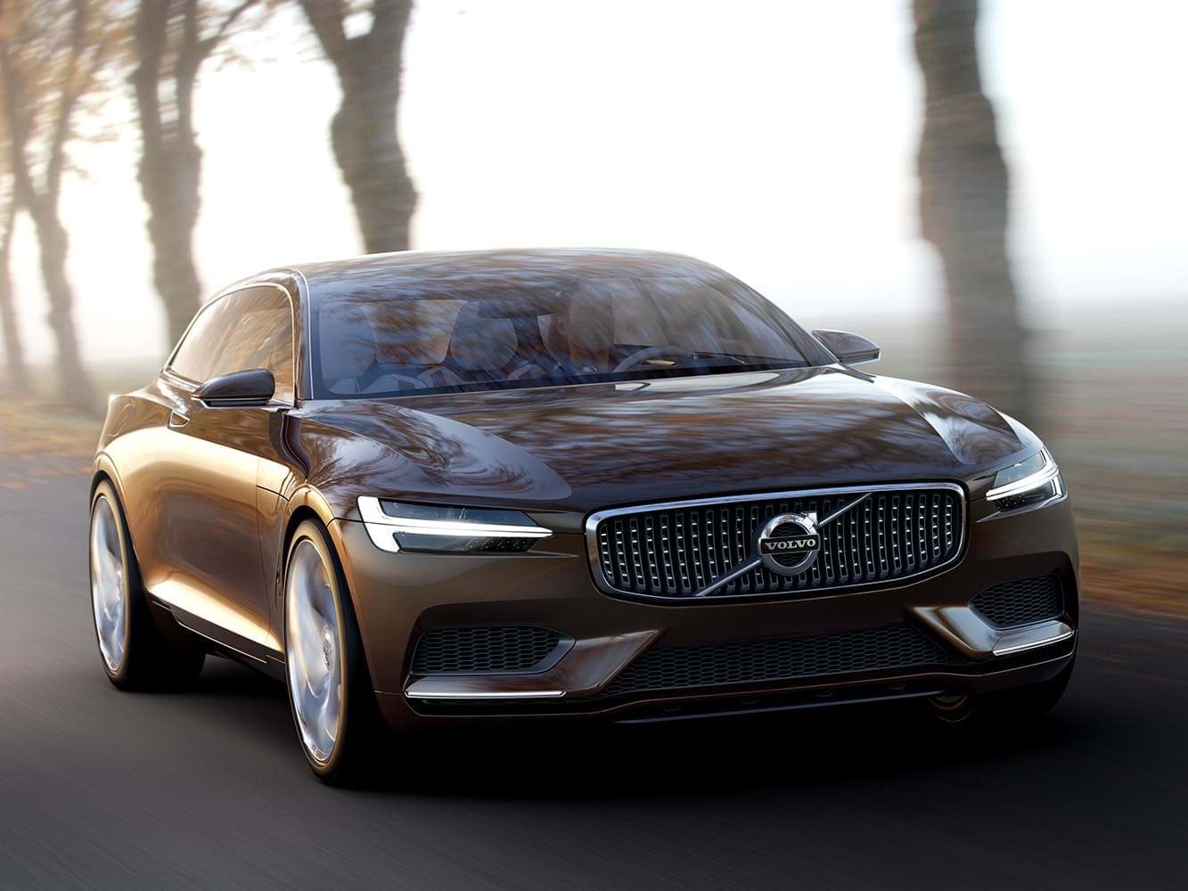 The Volvo Concept Estate drives along a tree-lined road