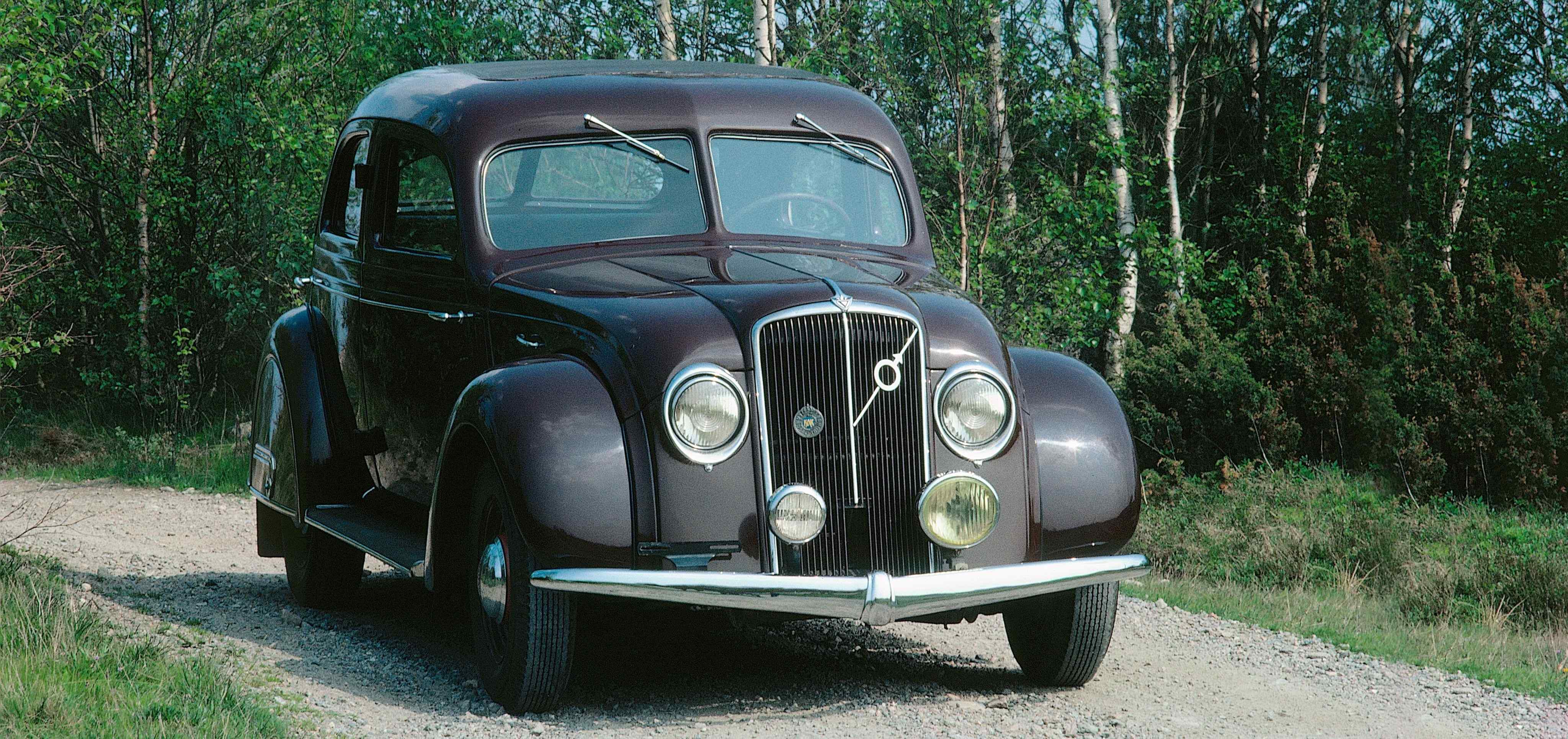 Volvo PV36 Carioca driving on gravel road in forest
