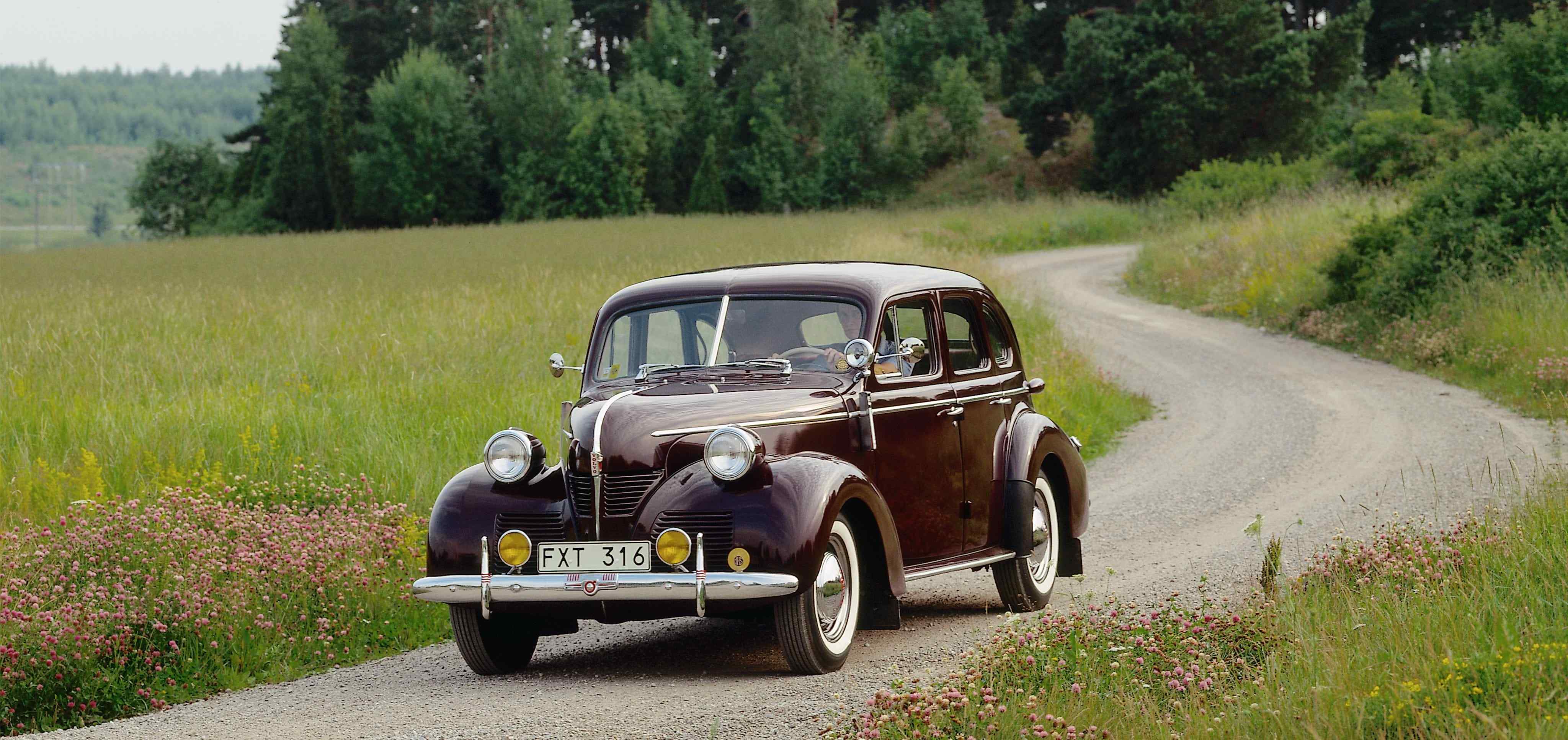 Volvo PV60-1 being driven along gravel track in countryside