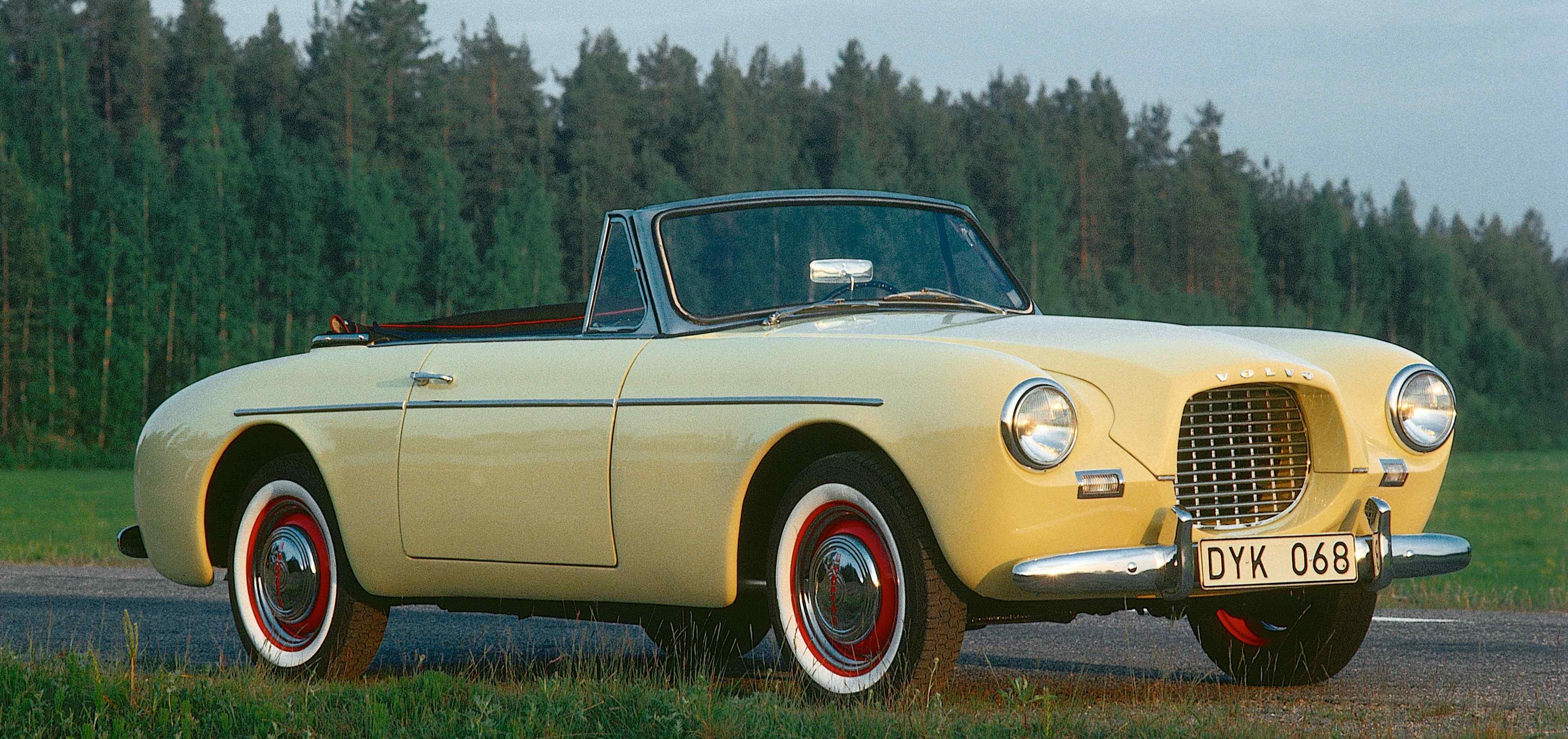 A yellow Volvo sport P1900 parked in countryside environment