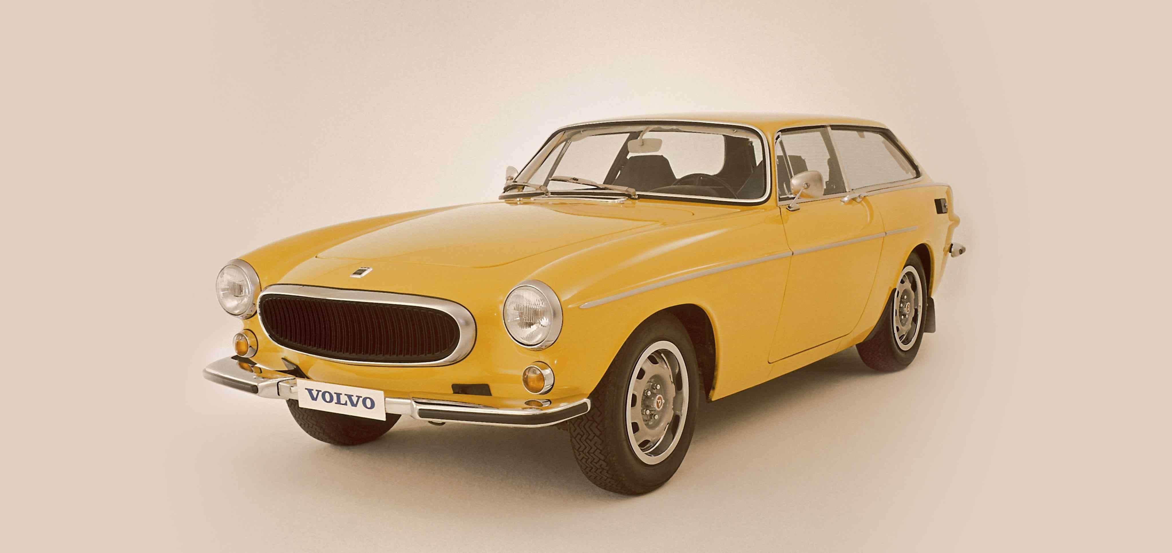 A yellow Volvo 1800ES seen from front left side