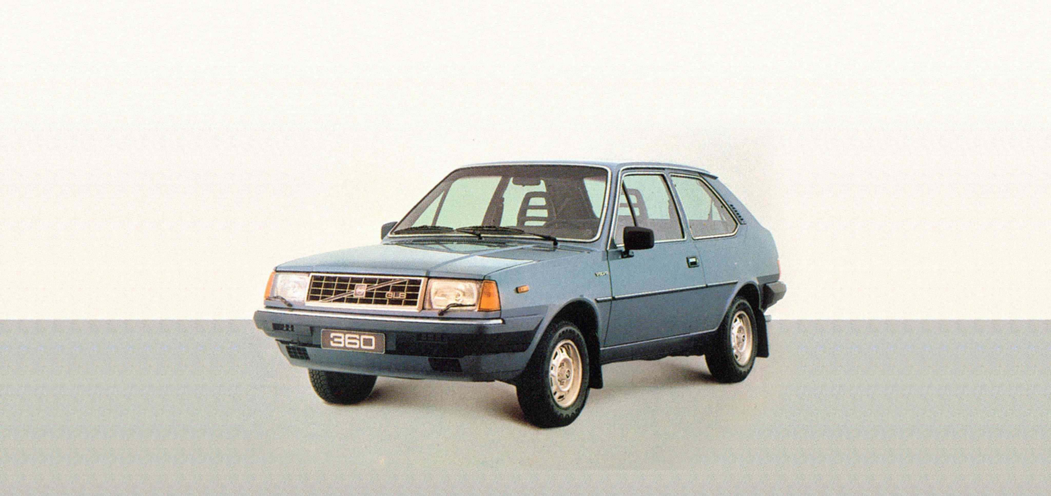 A blue 3-door Volvo 360 in a white studio environment