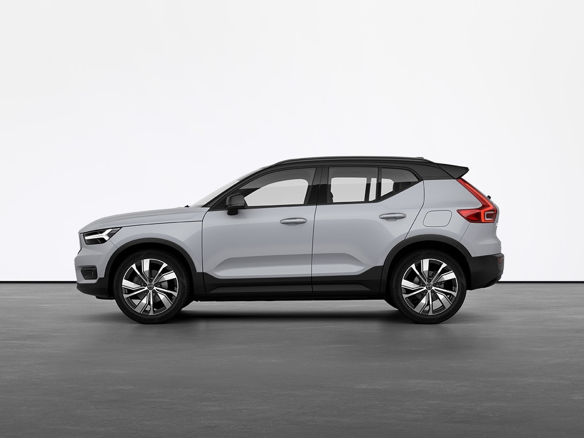 A grey Volvo XC40 full electric compact SUV standing still on grey floor in a studio