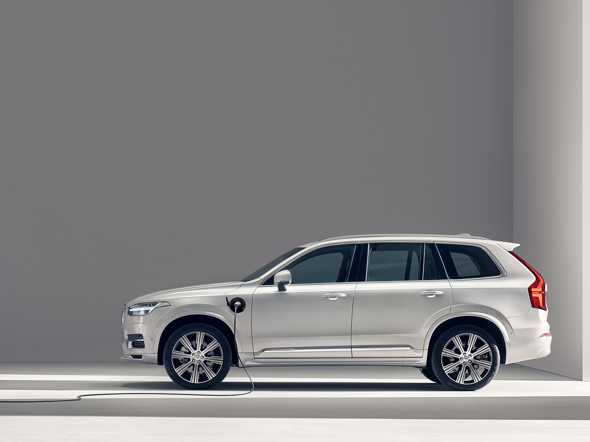 A Volvo XC90 Recharge plug-in hybrid SUV being charged.