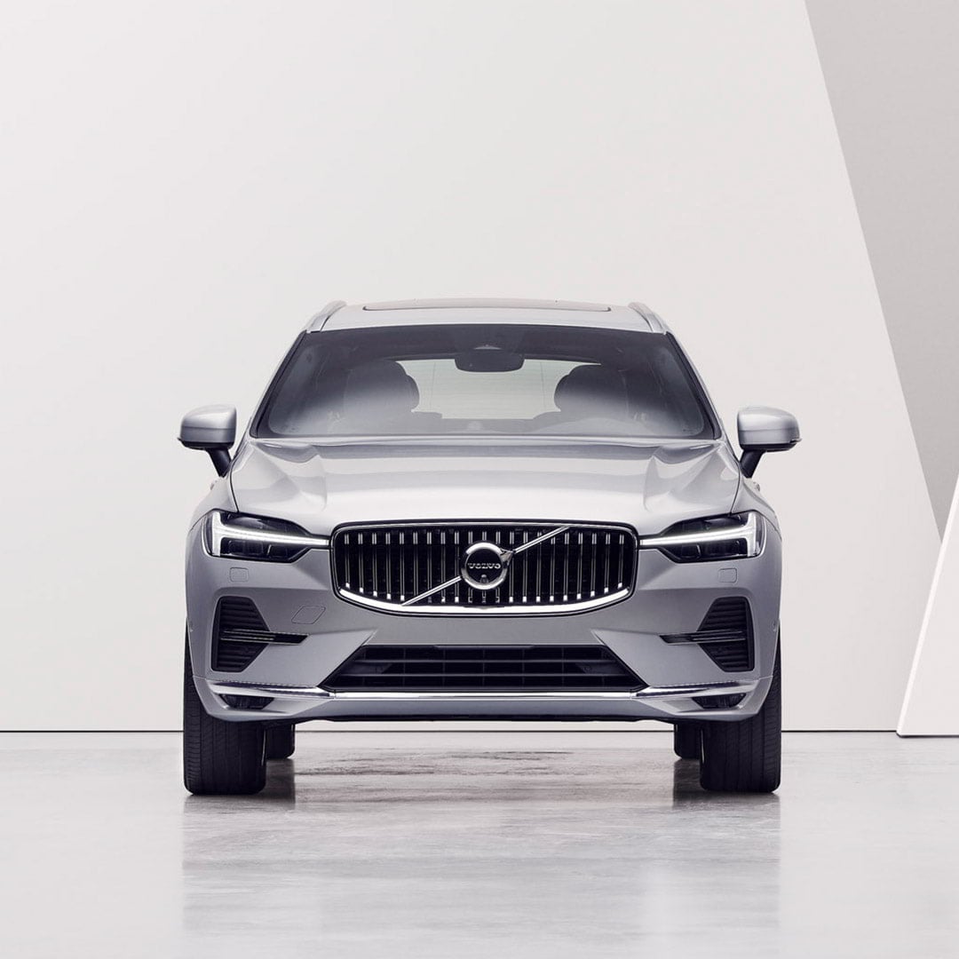 A woman looking at a Volvo XC60.
