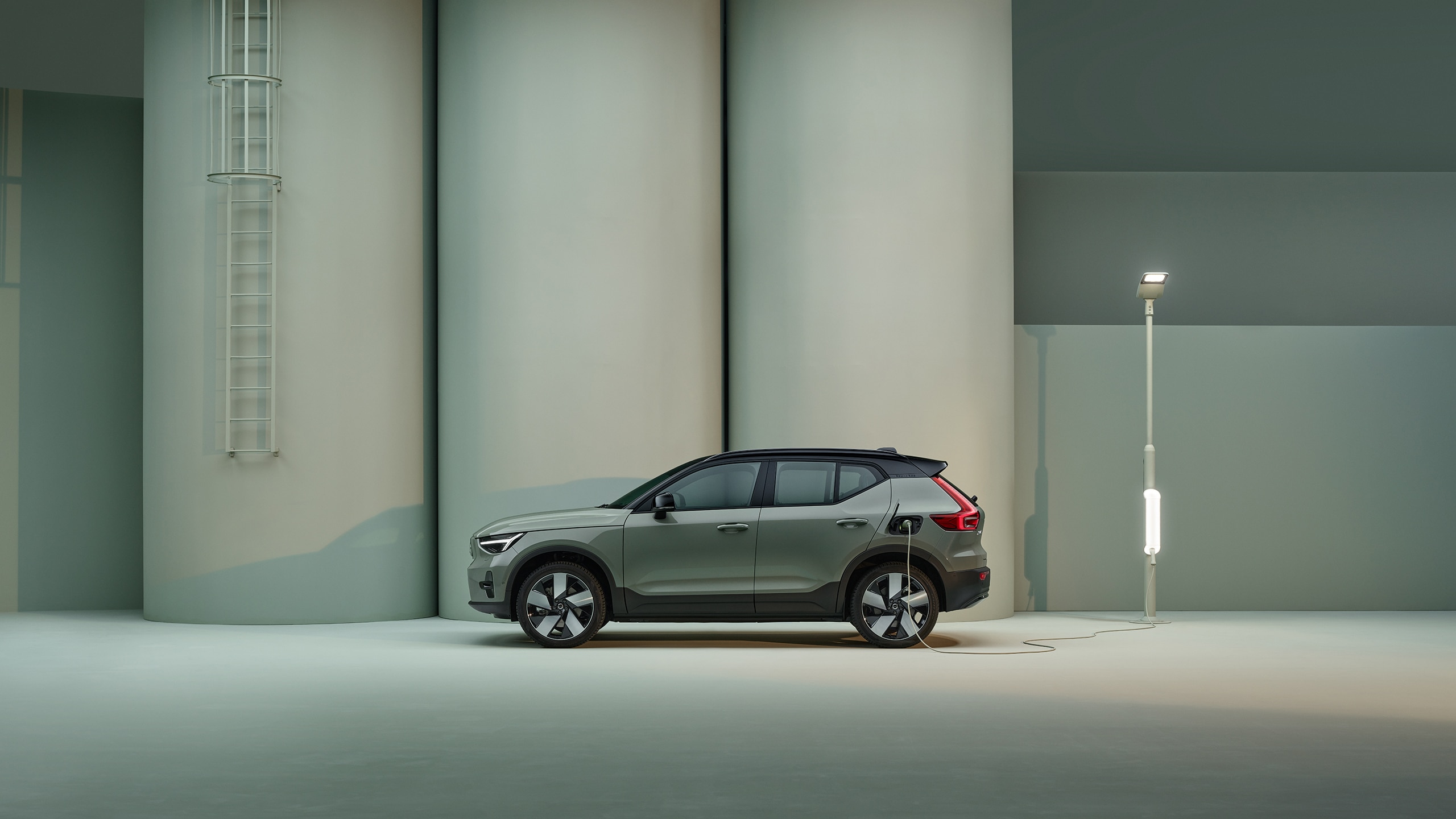 The side profile of a green Volvo XC40  Recharge pure electric SUV.