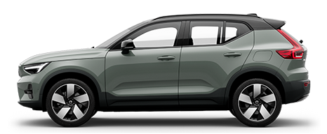 A green Volvo XC40 Recharge full electric compact SUV standing still on grey floor in a studio