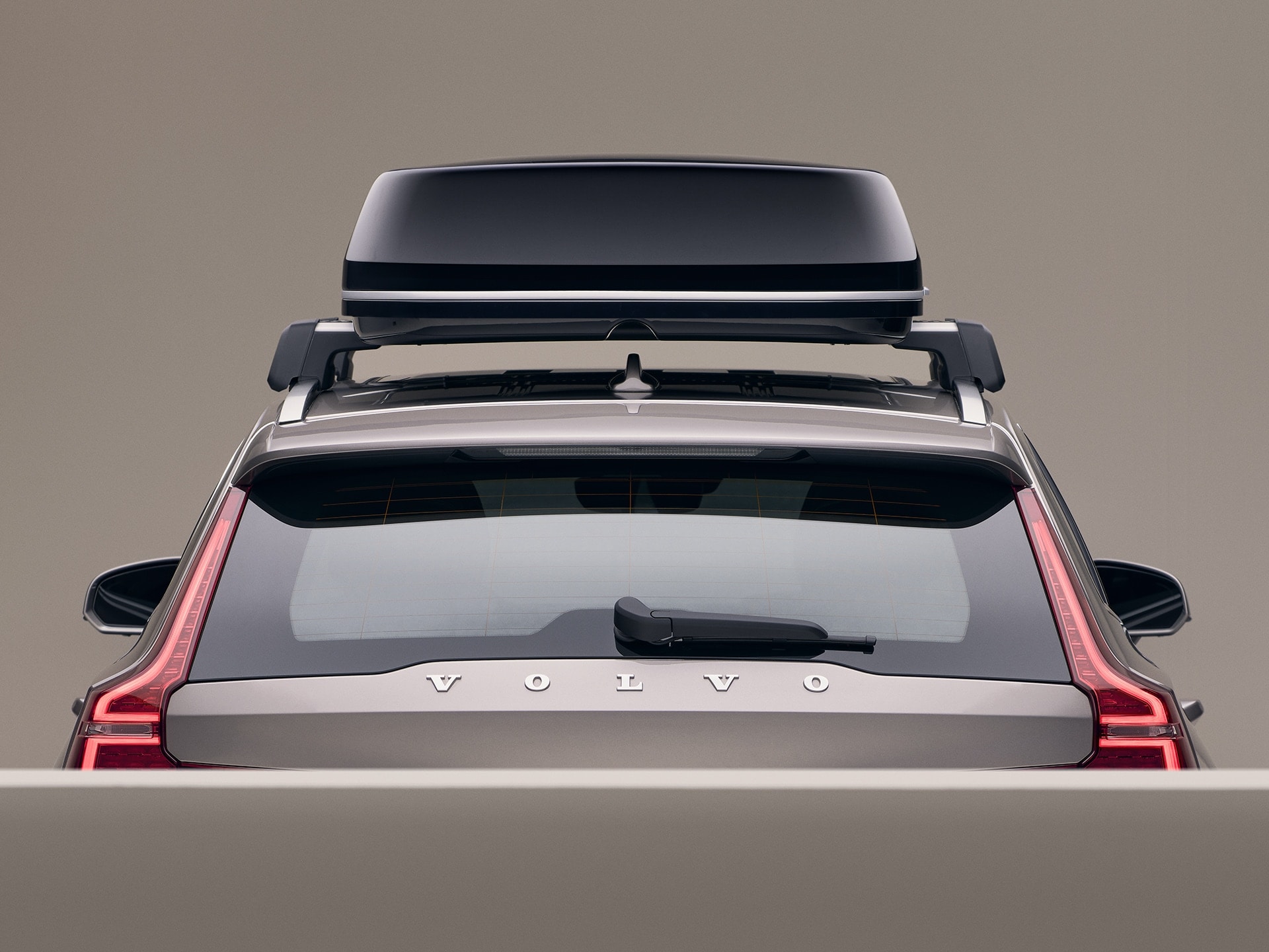 A Volvo V60 with a black roof box