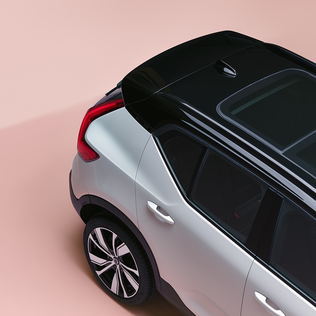 An XC40 Recharge from above, parked in a pink room