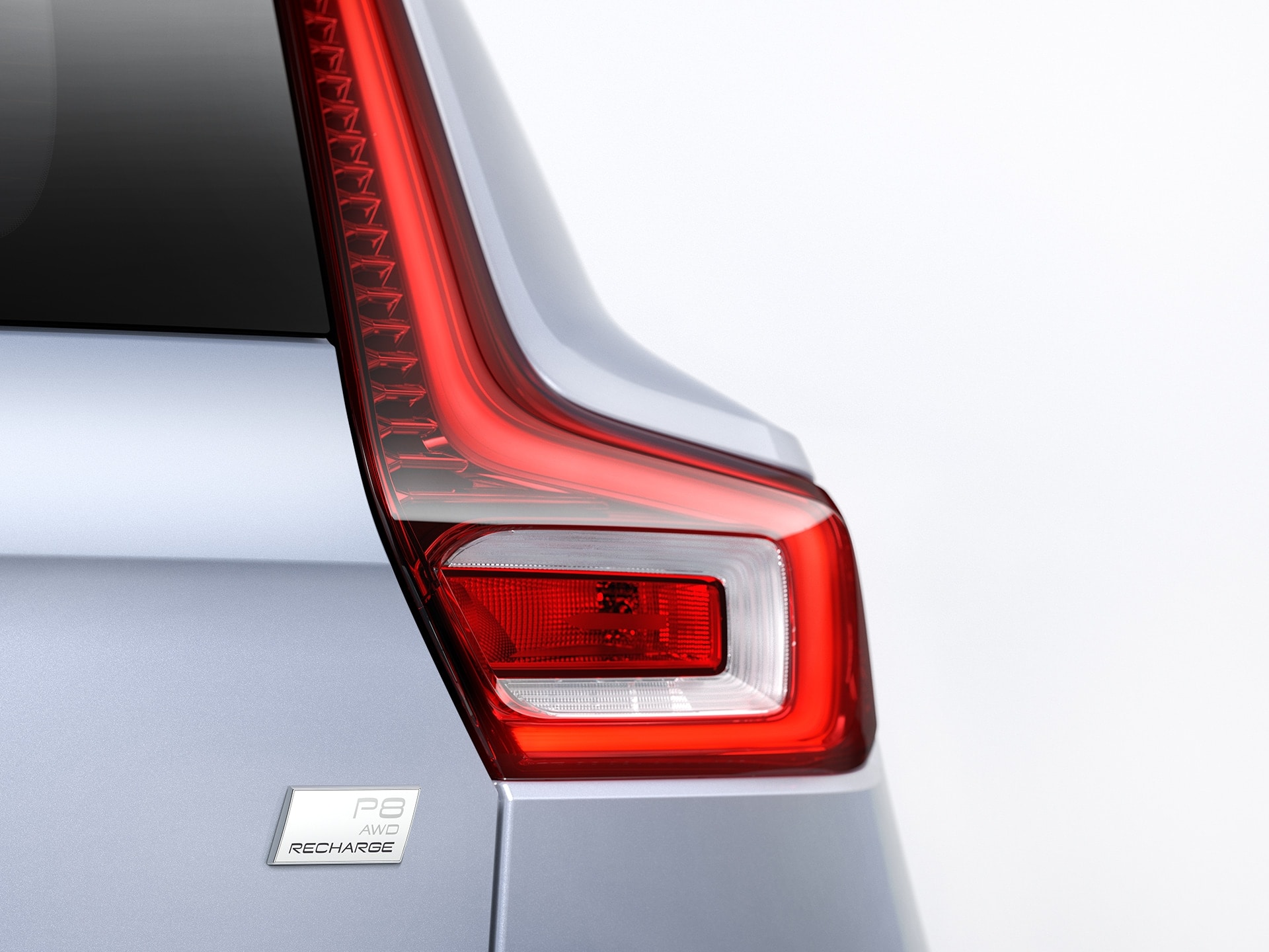 Detail of right taillight and Volvo Recharge badge on an XC40.