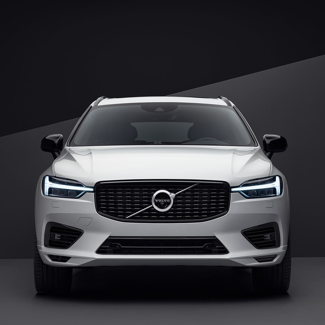 The front exterior of a white Volvo XC60 in a black surrounding