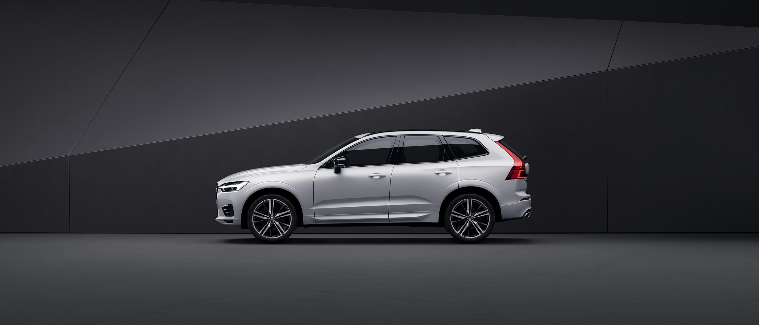 A white Volvo XC60 parked in a black surrounding