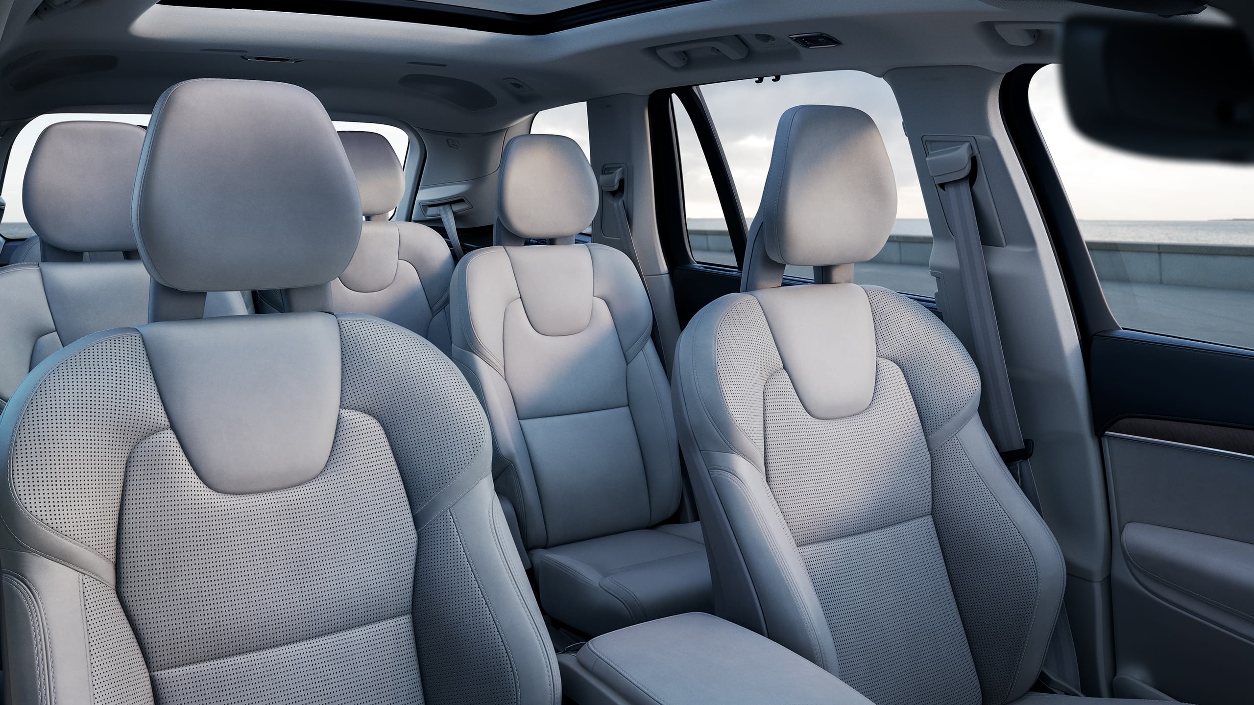 Inside a Volvo XC90 with 3 rows, blonde interior on seats