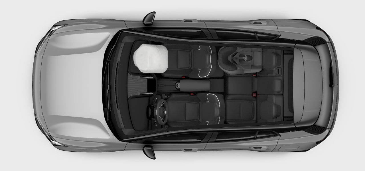 Vista cenital del interior del automóvil con un airbag desplegado y un sistema de retención infantil en el asiento trasero.